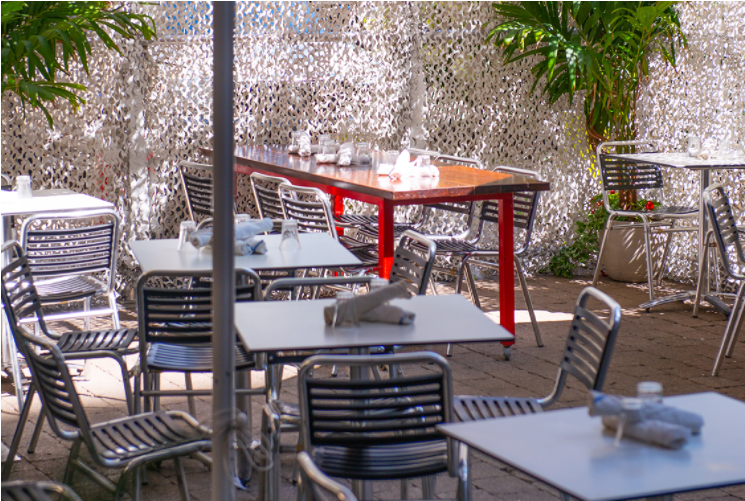 A patio with tables and chairs Description automatically generated with low confidence