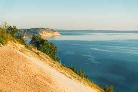 A sandy beach with a body of water in the background AI-generated content may be incorrect.